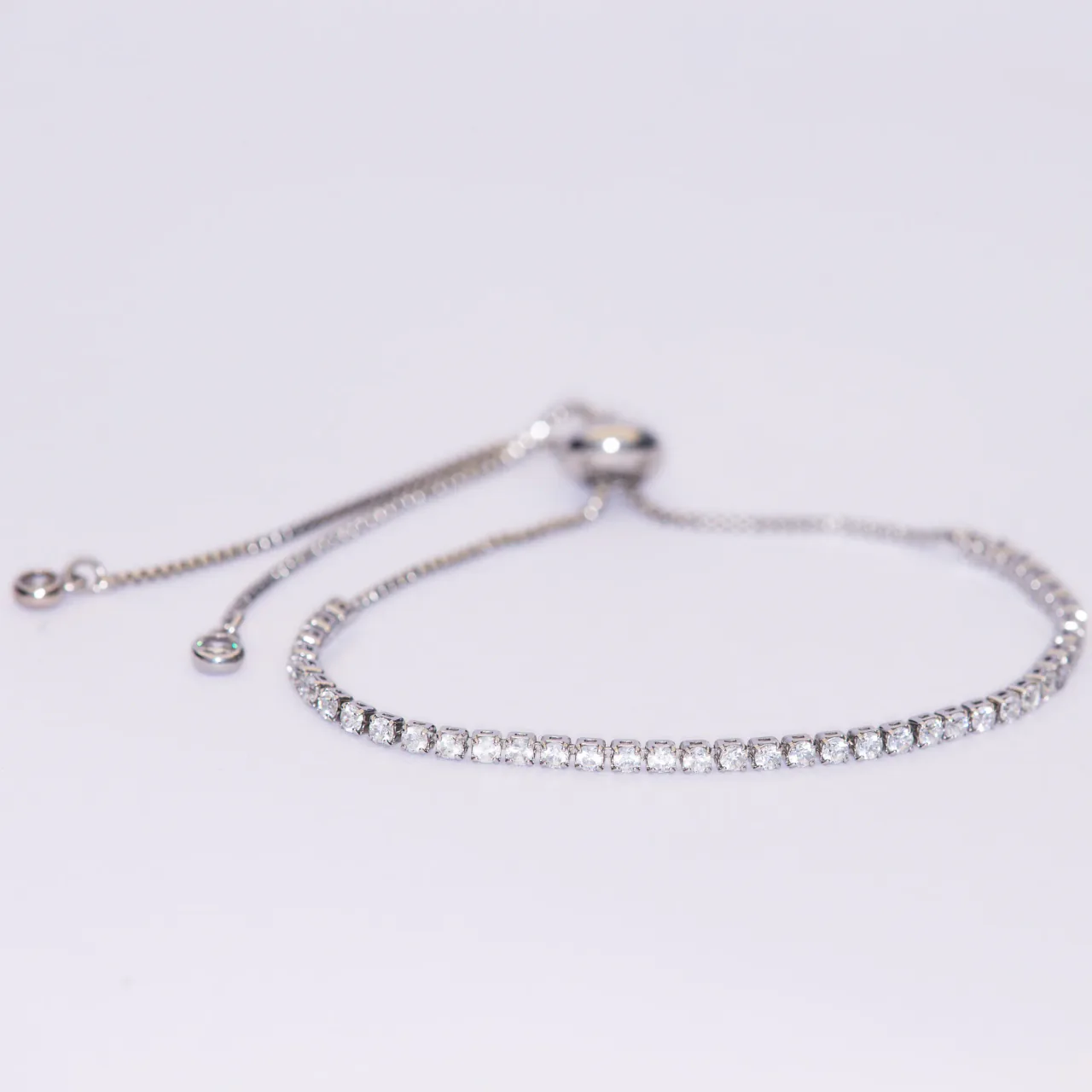 The Aria silver bracelet — a continuous line of stones on an adjustable slider chain