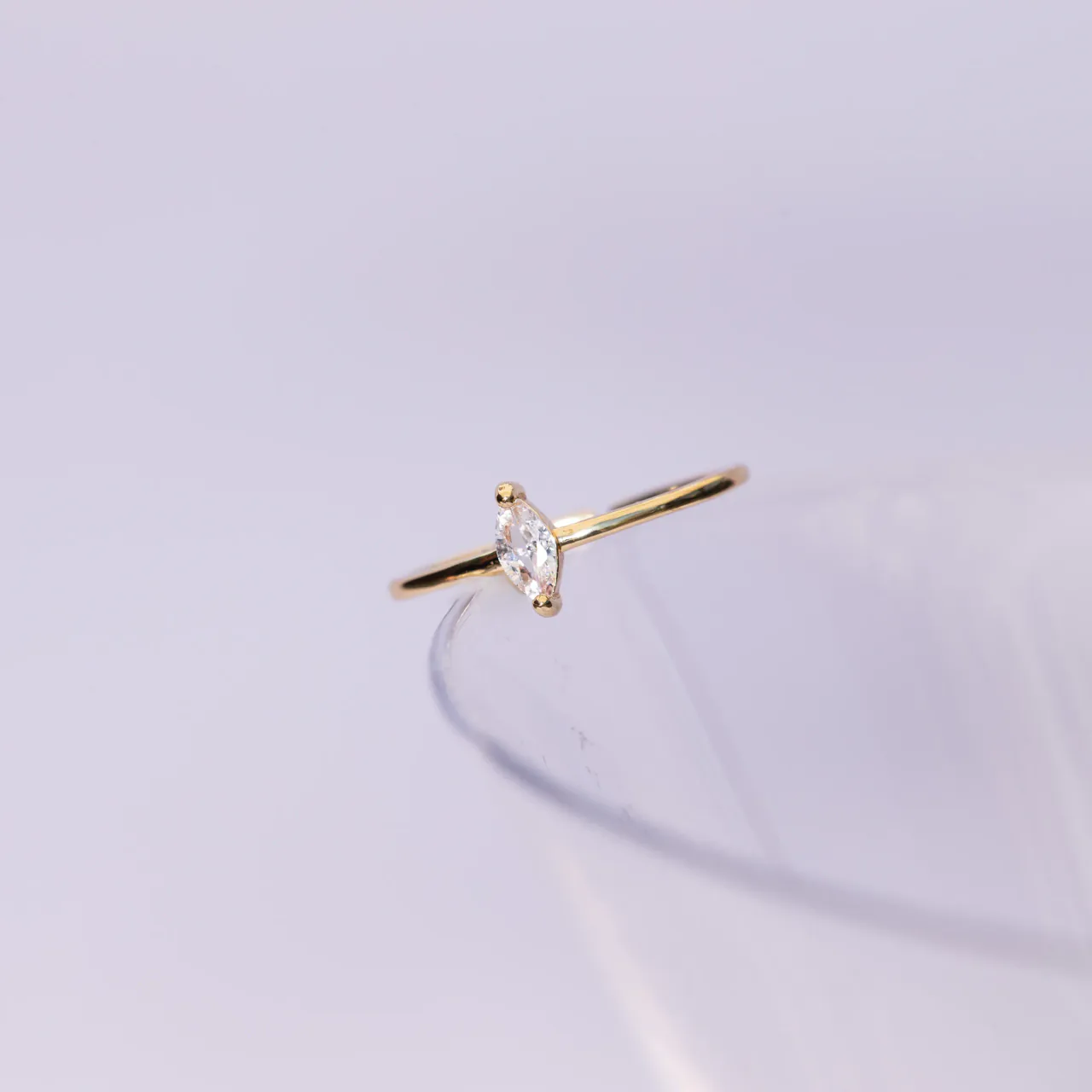 The Astra gold ring — a marquise-cut stone on a slim band