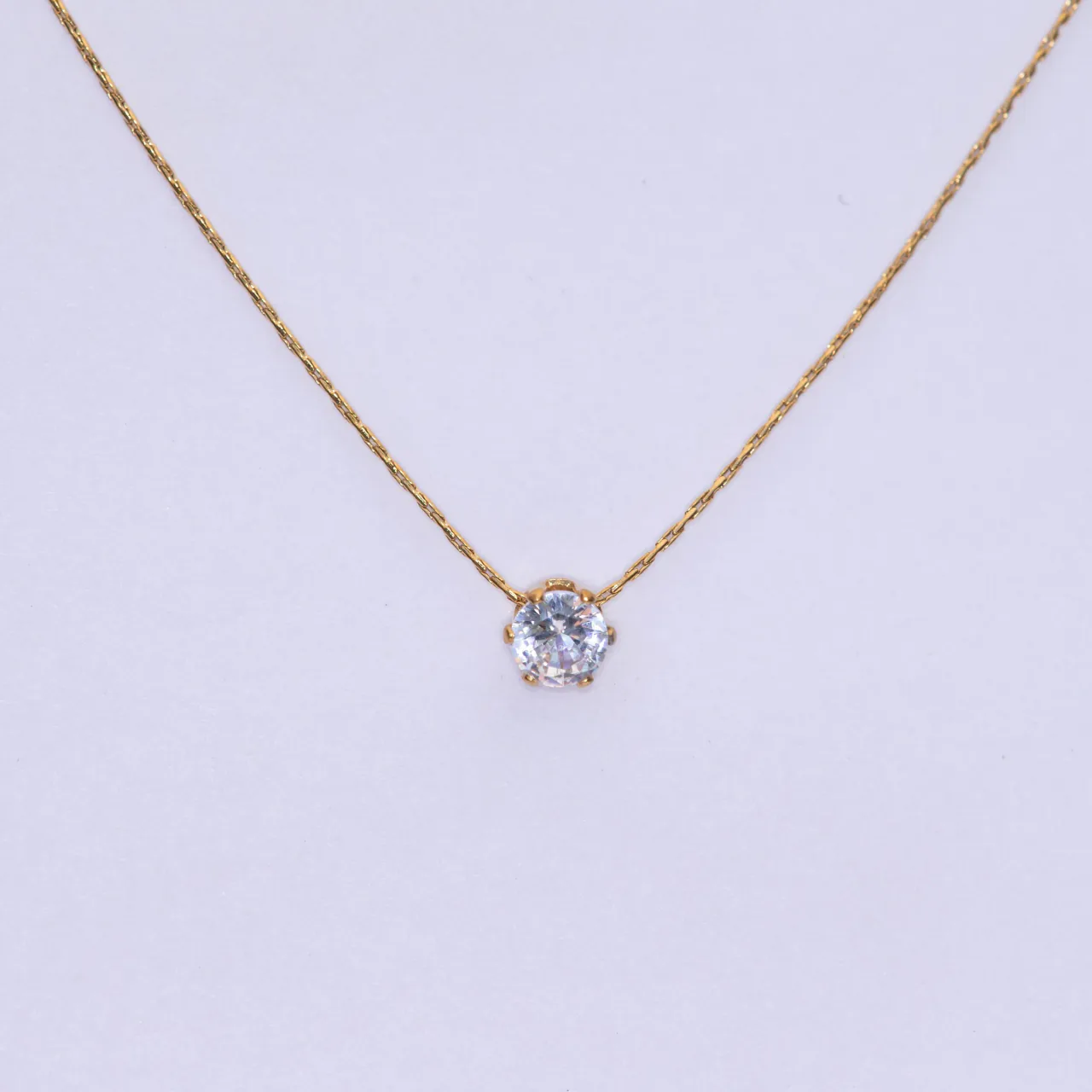 The Lumi gold necklace — a single round stone on a fine chain