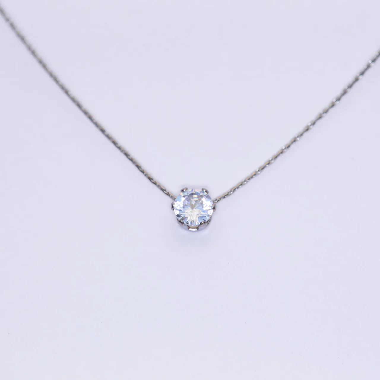 The Lumi silver necklace — a single round stone on a fine chain